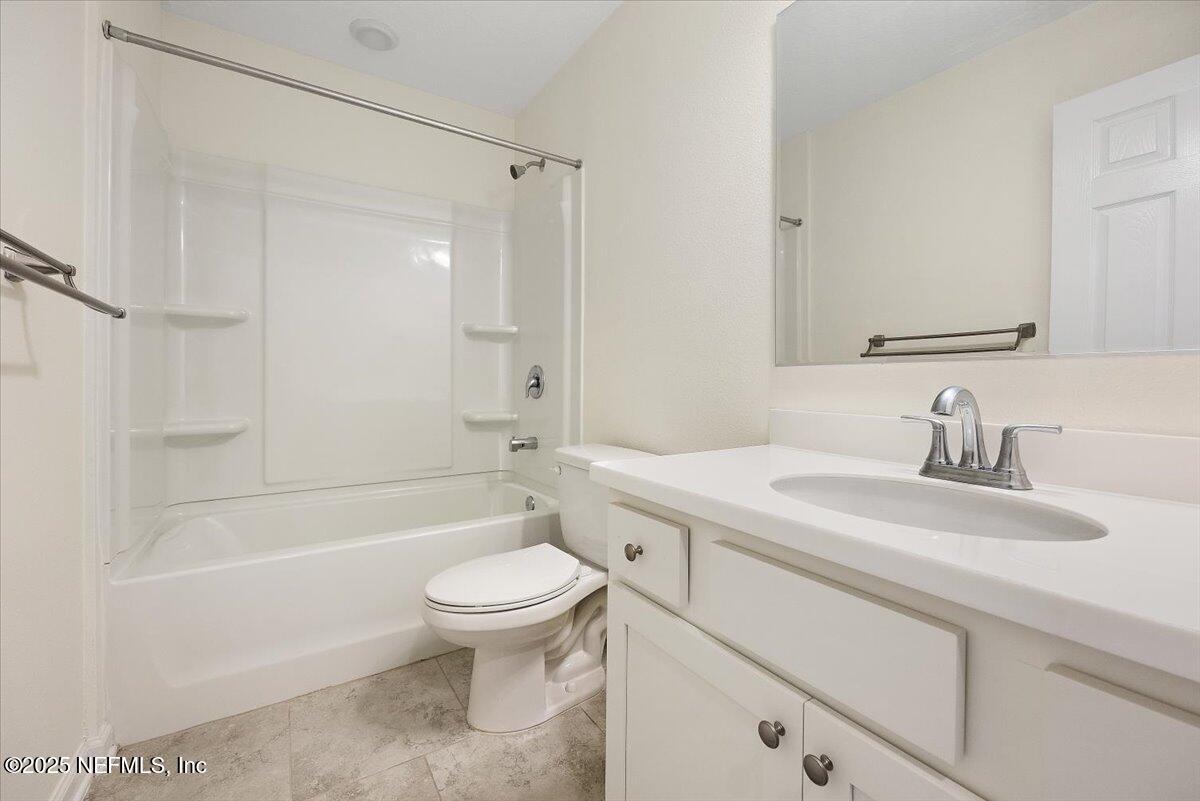 54 Ridge Lake Rd Street St. Augustine, FL 32086 - Photo 21 of 26 a bathroom with a sink a toilet and a bathtub
