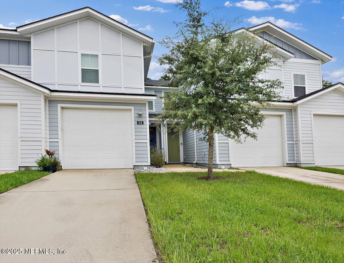 54 Ridge Lake Rd Street St. Augustine, FL 32086 - Photo 24 of 25 a front view of a house with a yard and garage