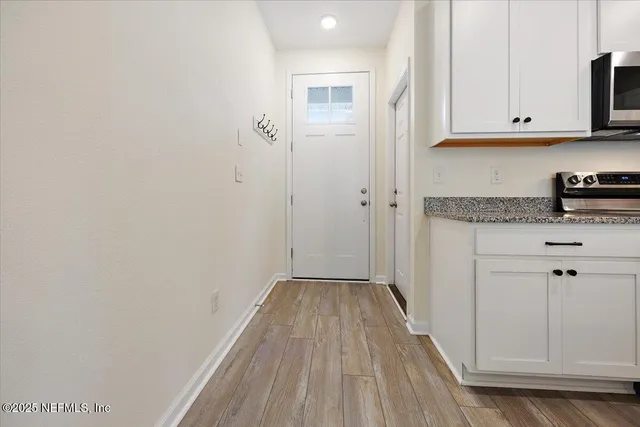 a kitchen with stainless steel appliances granite countertop a refrigerator stove microwave and sink