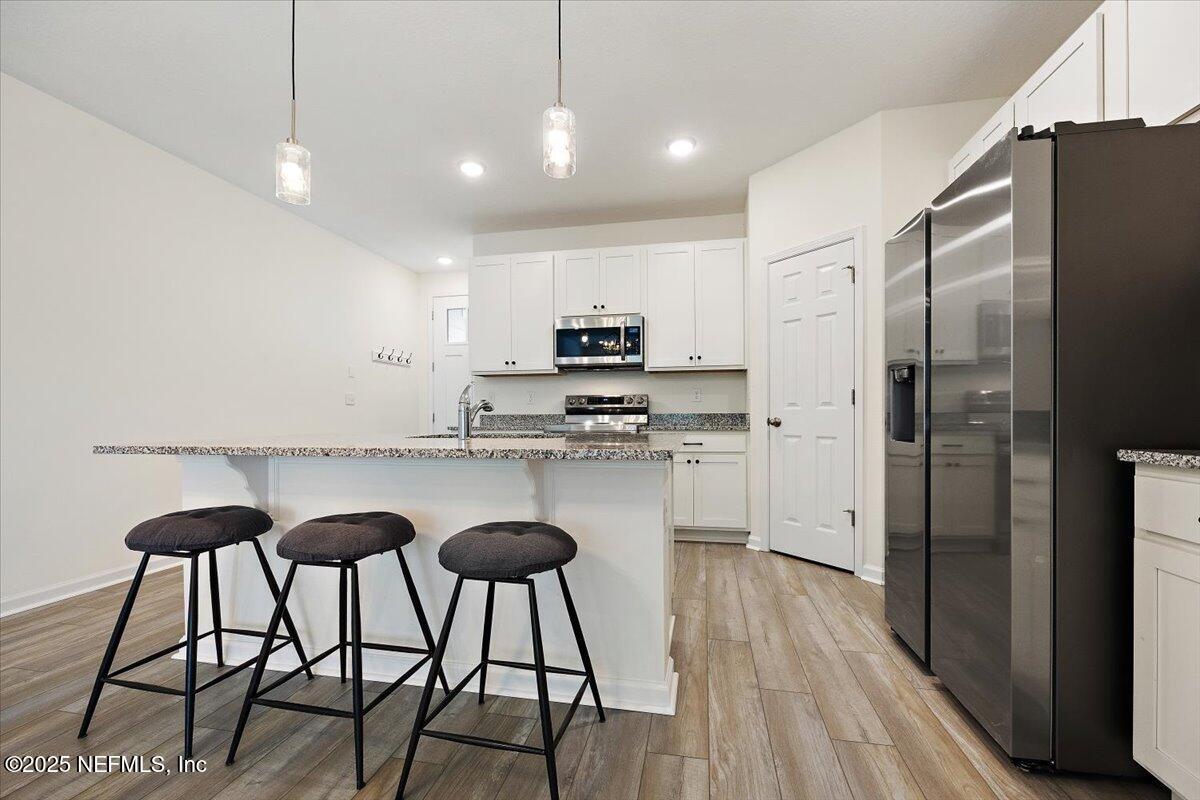 54 Ridge Lake Rd Street St. Augustine, FL 32086 - Photo 5 of 25 a kitchen with stainless steel appliances granite countertop a stove a refrigerator and a sink