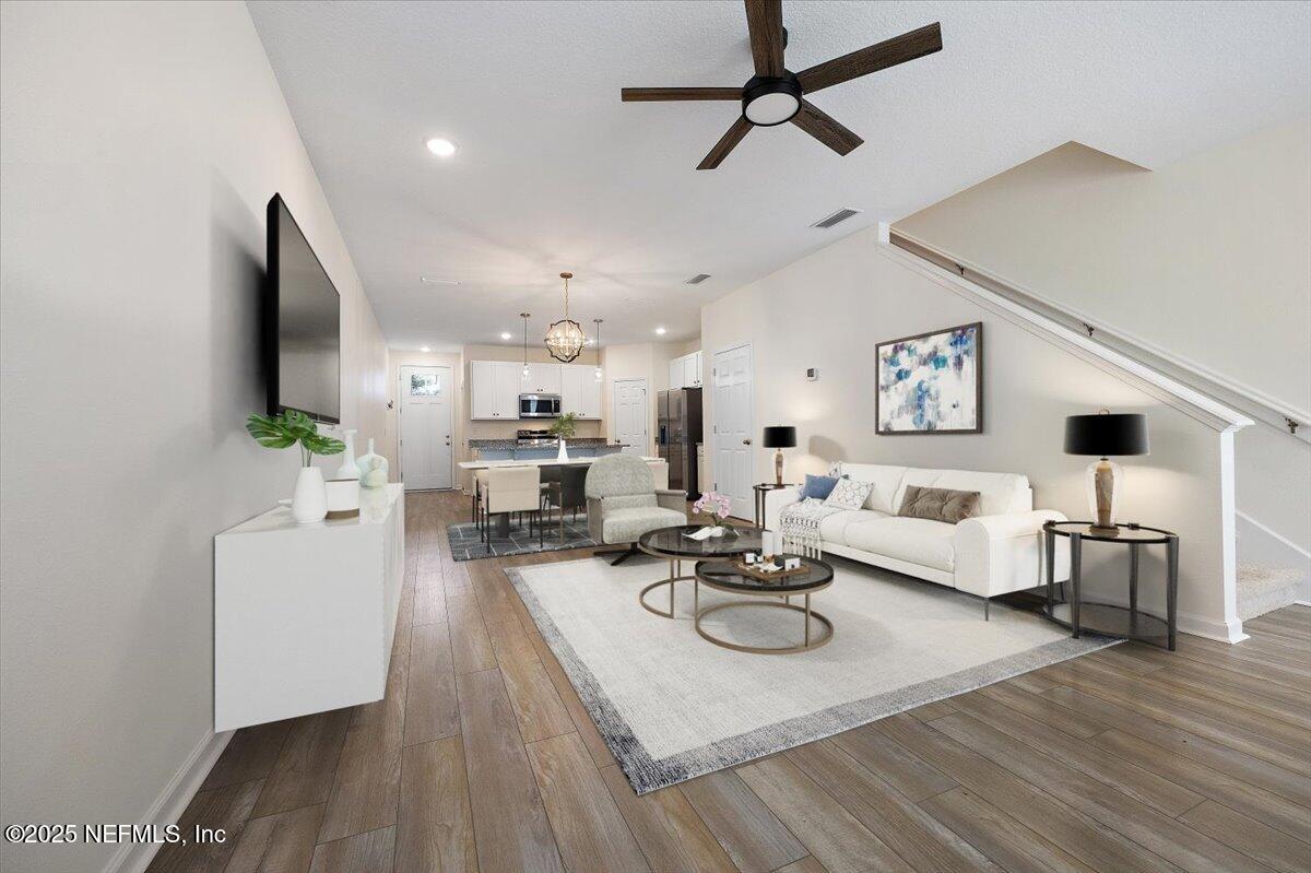 54 Ridge Lake Rd Street St. Augustine, FL 32086 - Photo 6 of 25 a living room with furniture kitchen view and a wooden floor