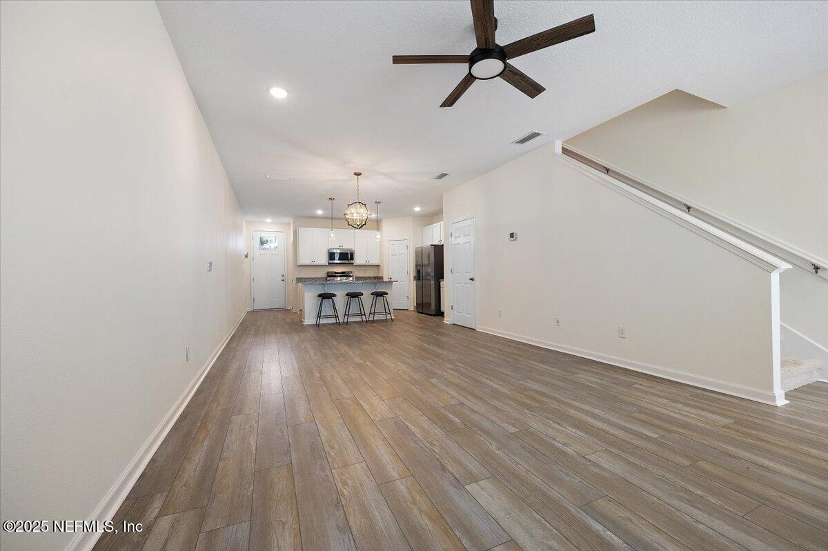 54 Ridge Lake Rd Street St. Augustine, FL 32086 - Photo 9 of 26 wooden floor in an empty room with a window