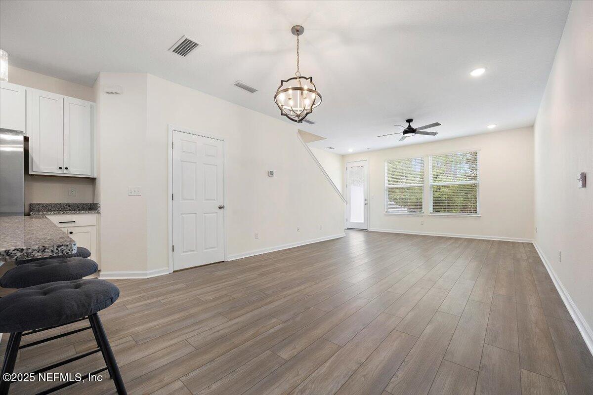 54 Ridge Lake Rd Street St. Augustine, FL 32086 - Photo 10 of 26 a view of an empty room with wooden floor and a window