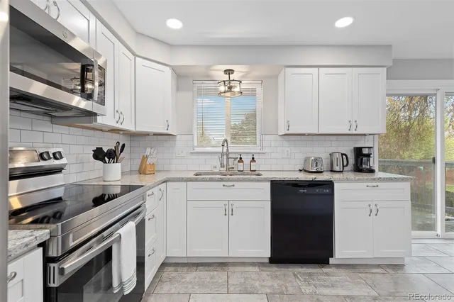 a kitchen with a sink stove and cabinets
