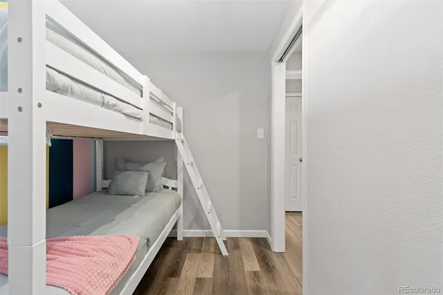 a bedroom with a bed and a mirror
