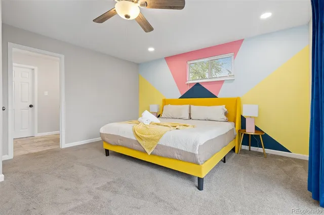 a bedroom with a bed and painting on the wall