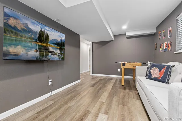 a living room with furniture and a wooden floor