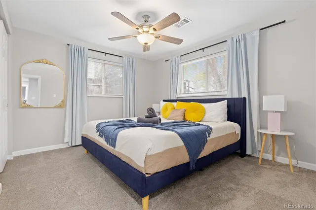 a bedroom with a bed lamp and a window