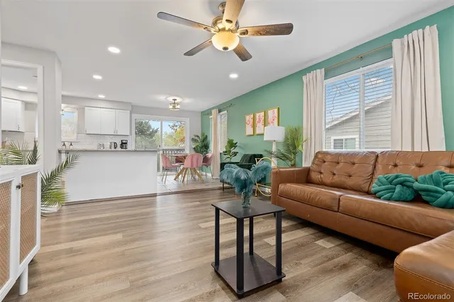a living room with furniture and kitchen view