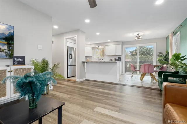 a living room with kitchen island furniture and a wooden floor