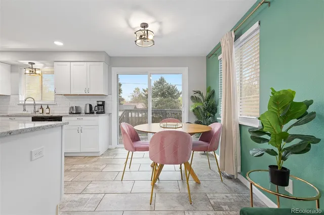 a dining room filled chandelier and fireplace
