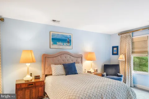 a bedroom with a bed and a lamp