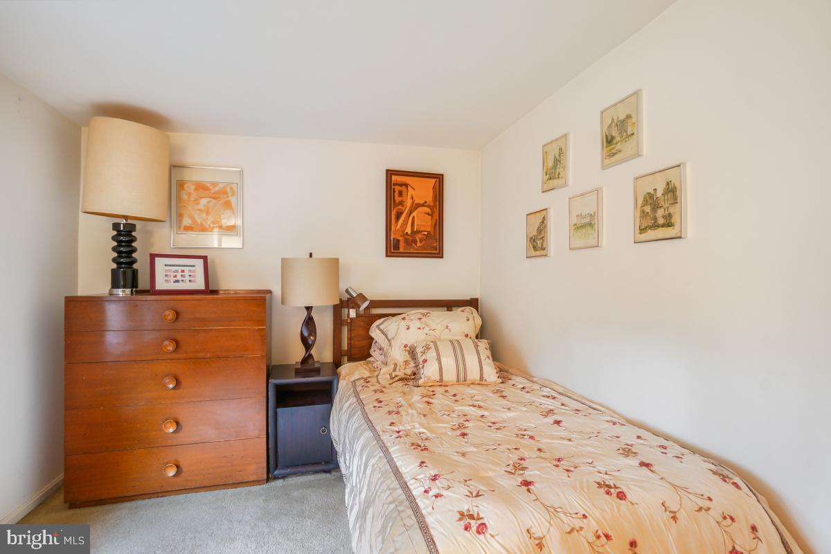 11521 Twining Lane Potomac, MD 20854 - Photo 24 of 31 a bedroom with a bed and a cabinets