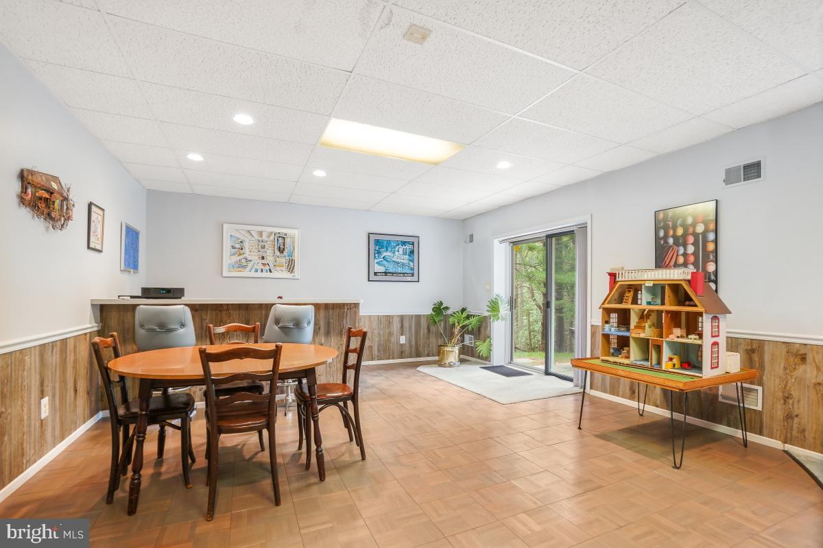 11521 Twining Lane Potomac, MD 20854 - Photo 25 of 31 a dining room with furniture and a floor to ceiling window