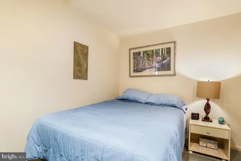 a bedroom with a bed and a wall painting