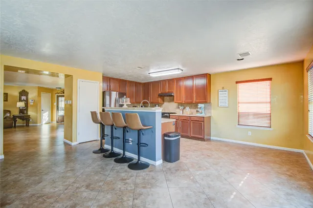 a kitchen with a sink cabinets and window