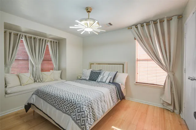 a bedroom with a large bed and a chandelier
