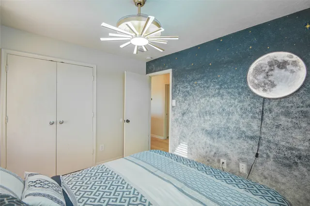 a bedroom with a bed and a chandelier