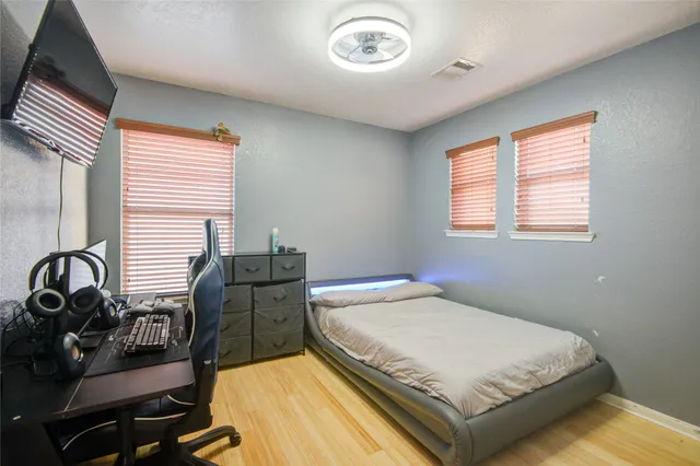 a bedroom with a bed and a large window