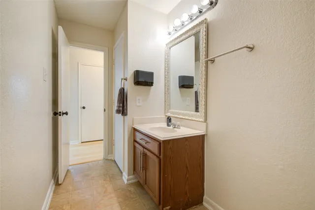 a bathroom with a sink a mirror and shower