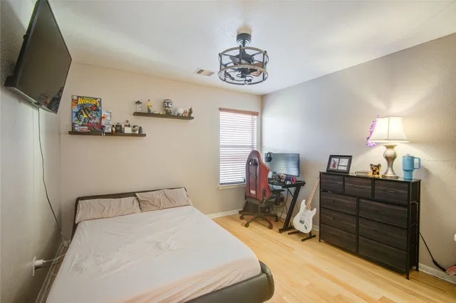 a bedroom with a bed and a chandelier