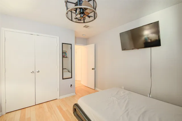 a bedroom with a bed and a flat screen tv