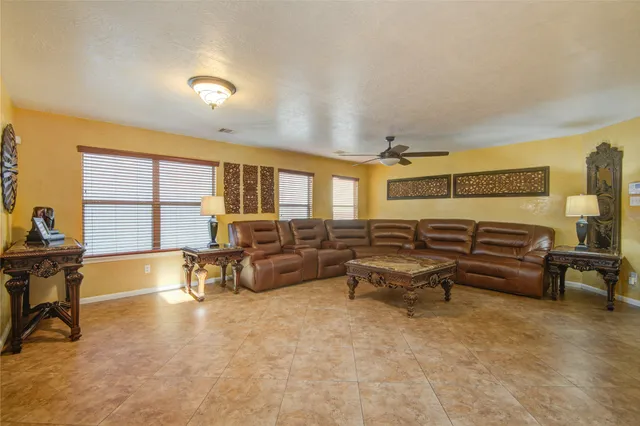 a living room with furniture and a large window