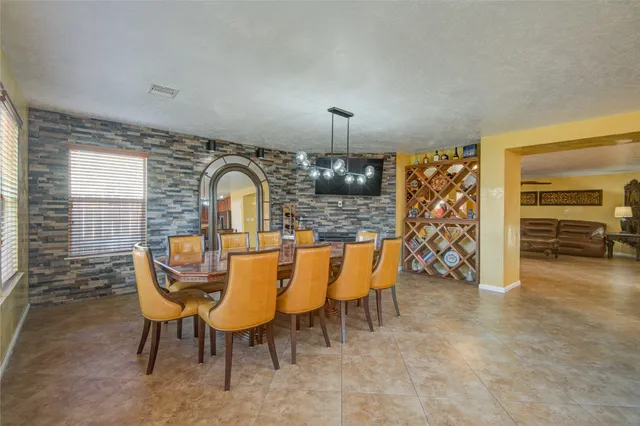 a view of a dining room with furniture and chandelier