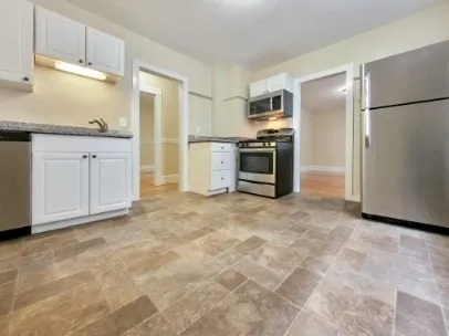 a kitchen with stainless steel appliances a refrigerator and a stove