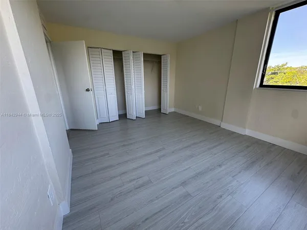 a view of a room with wooden floor and wall
