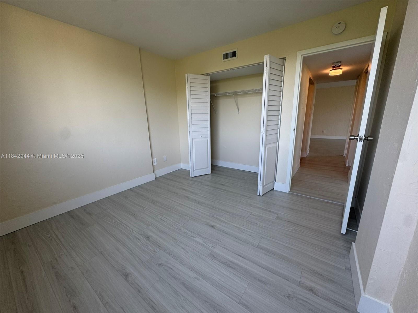 2715 Tigertail Avenue, Unit 404 Miami, FL 33133 - Photo 13 of 22 wooden floor in an empty room
