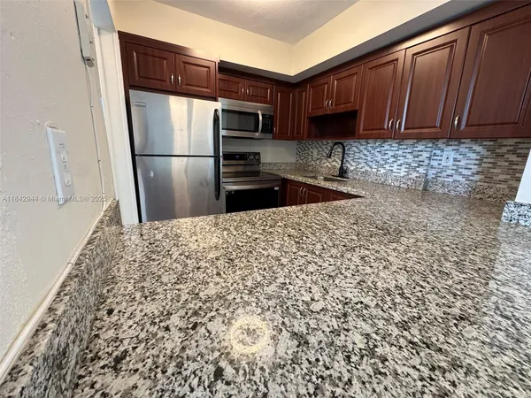 a kitchen with a refrigerator and a sink