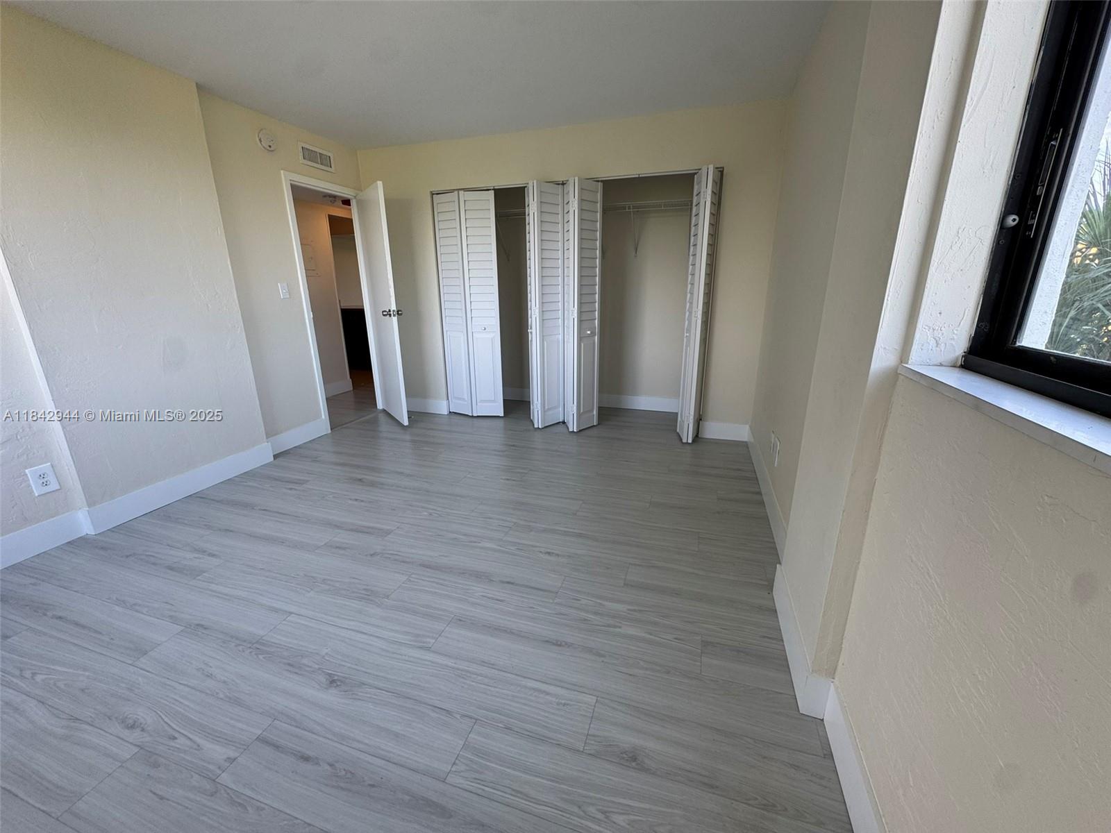 2715 Tigertail Avenue, Unit 404 Miami, FL 33133 - Photo 10 of 22 a view of a room with wooden floor and closet