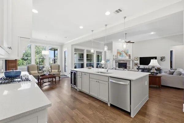 a large kitchen with kitchen island a island a stove a table and chairs in it