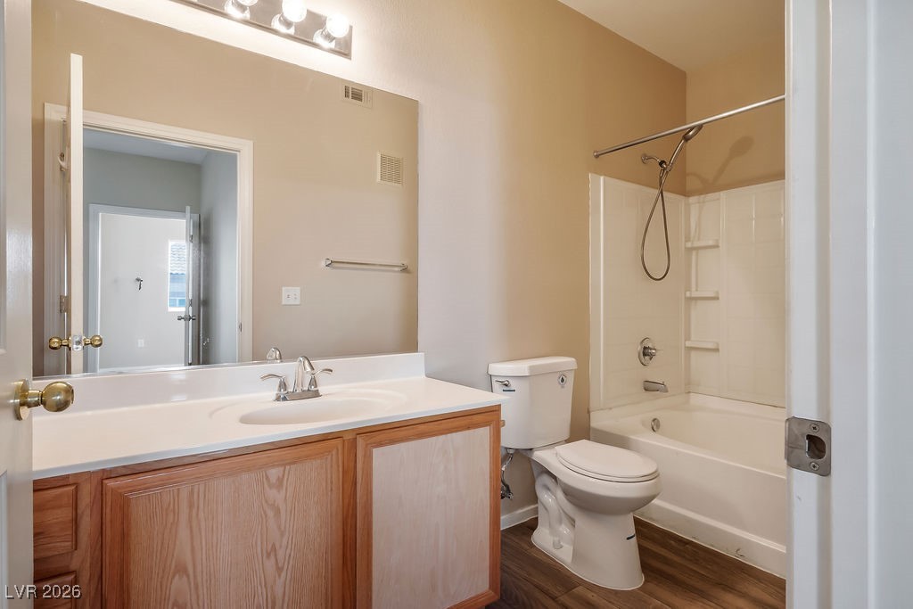 4655 Gold Dust Avenue, Unit 211 Las Vegas, NV 89120 - Photo 15 of 24 Bathroom featuring tub / shower combination, vanity, and dark wood-style flooring