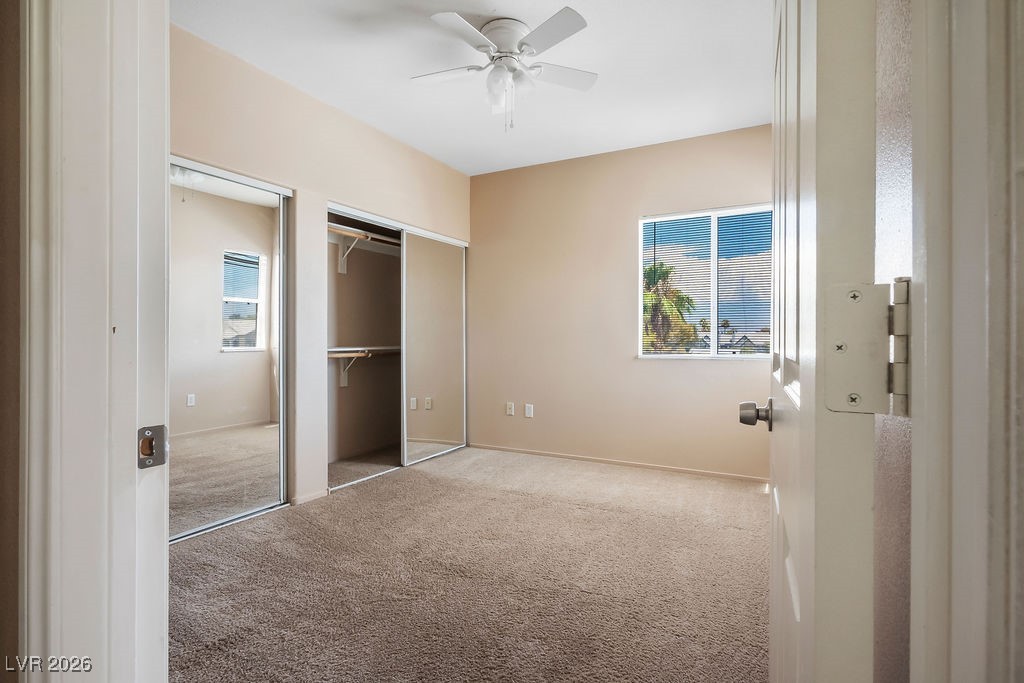 4655 Gold Dust Avenue, Unit 211 Las Vegas, NV 89120 - Photo 16 of 24 Unfurnished bedroom featuring carpet, multiple windows, a closet, and a ceiling fan