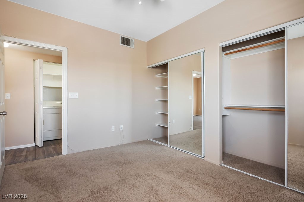 4655 Gold Dust Avenue, Unit 211 Las Vegas, NV 89120 - Photo 18 of 24 Unfurnished bedroom with washer / clothes dryer, carpet, and multiple closets