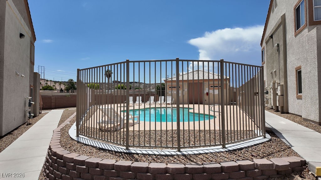4655 Gold Dust Avenue, Unit 211 Las Vegas, NV 89120 - Photo 23 of 24 Community pool with a patio area and a fenced backyard