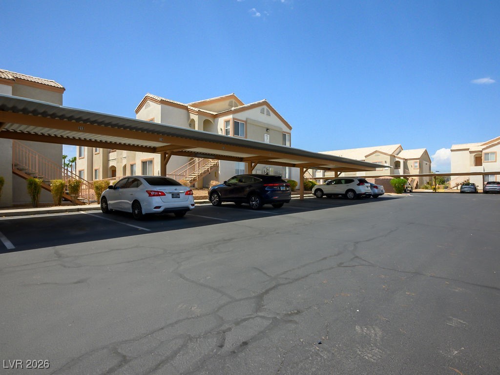4655 Gold Dust Avenue, Unit 211 Las Vegas, NV 89120 - Photo 24 of 24 Covered parking lot featuring stairway and a residential view