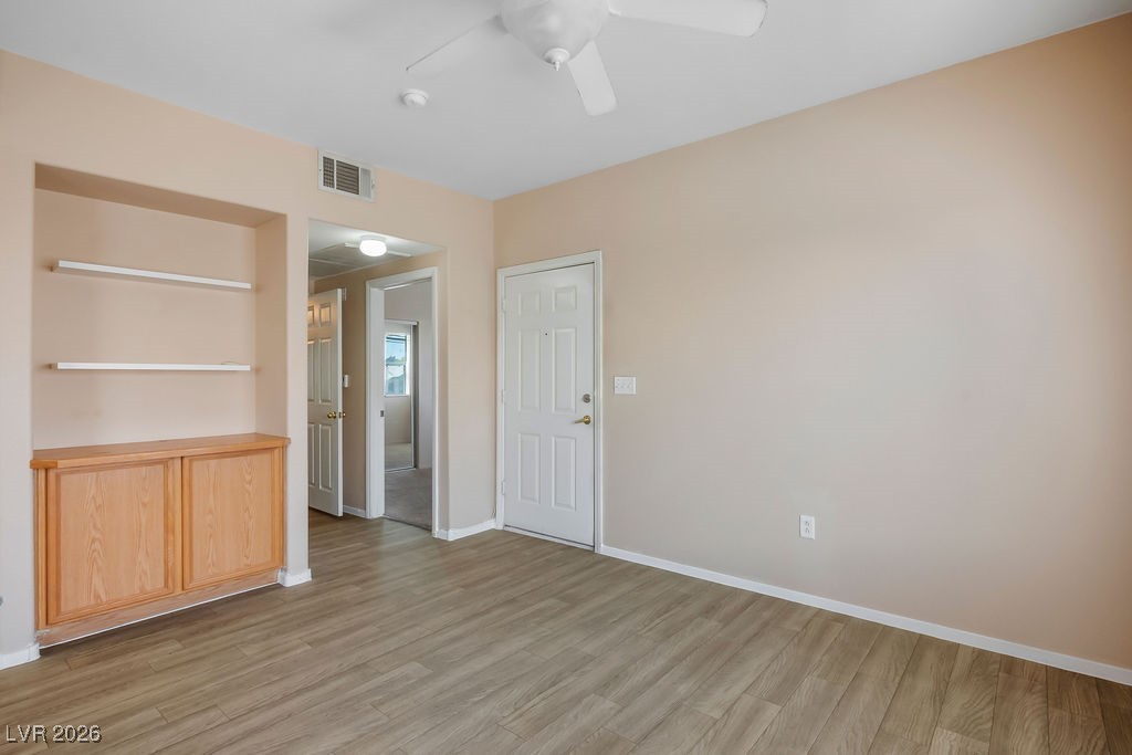 4655 Gold Dust Avenue, Unit 211 Las Vegas, NV 89120 - Photo 4 of 24 Spare room featuring light wood-style floors and ceiling fan