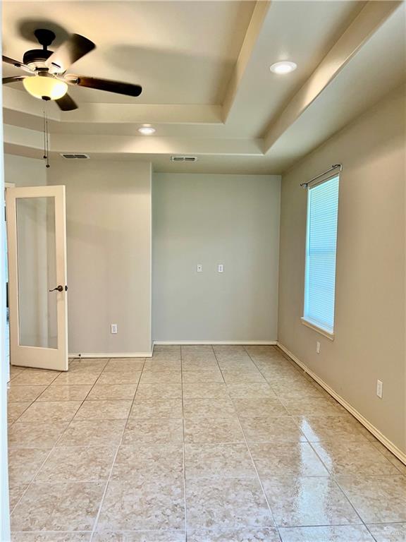 20724 North Fm 493 Road Edinburg, TX 78542 - Photo 8 of 29 Spare room featuring a ceiling fan, a tray ceiling, recessed lighting, light tile patterned floors, and visible vents
