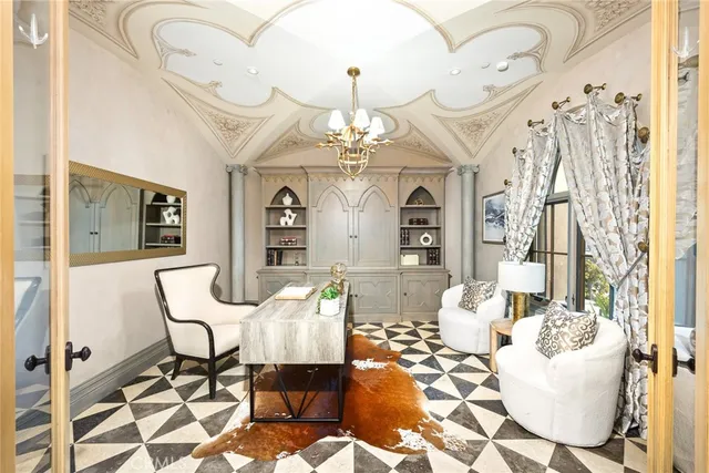 a dining room with wooden floor a chandelier a flat screen tv and balcony