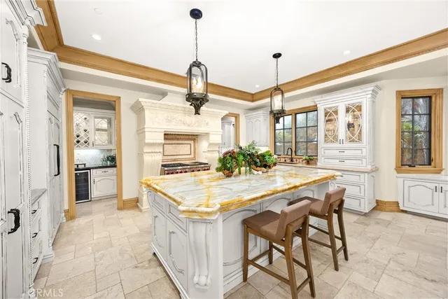 a kitchen with white cabinets and sink
