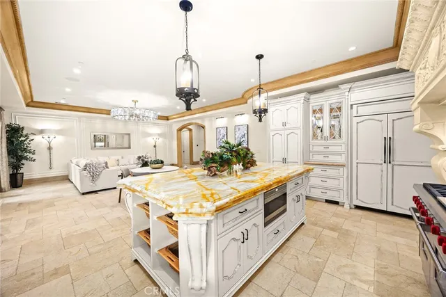 a kitchen with a stove and a white wooden cabinets