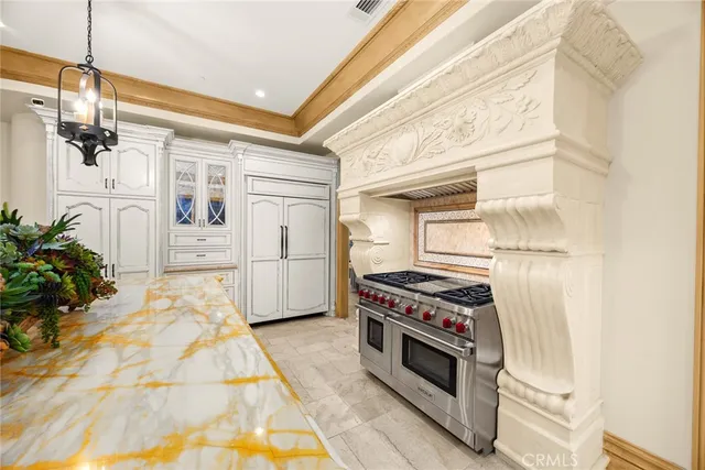 a spacious bedroom with a bed and a chandelier