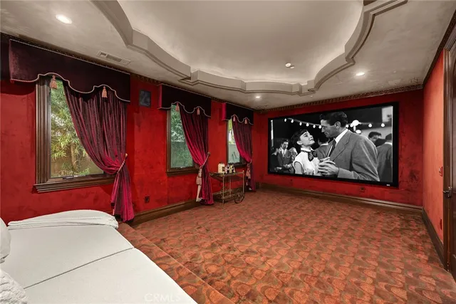 a living room with furniture and wall paintings