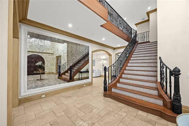 a spacious bedroom with a bed and a chandelier