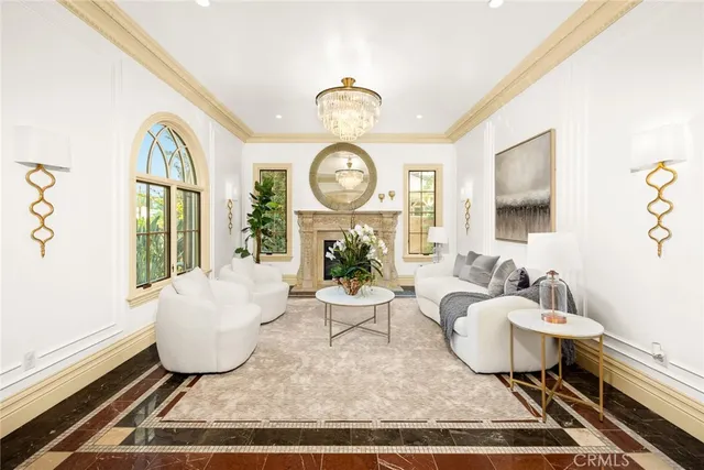 a living room with furniture a potted plant and a fireplace
