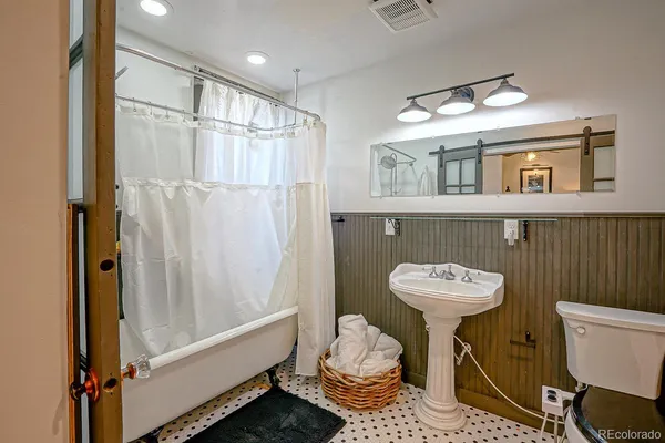 a bathroom with a sink toilet and shower