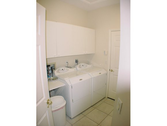 8949 Lely Island Circle Naples, FL 34113 - Photo 11 of 11 a utility room with dryer and washer
